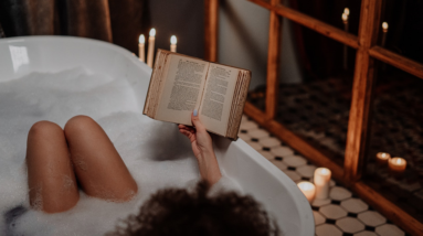 woman reading a book in a bubble bath