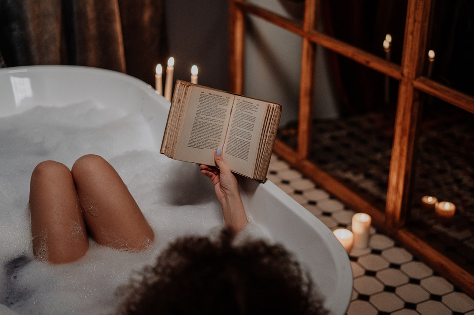 woman reading a book in a bubble bath