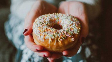 woman hands holding a donut