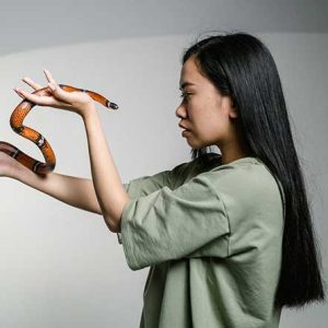 women holding a snake to overcome her fear