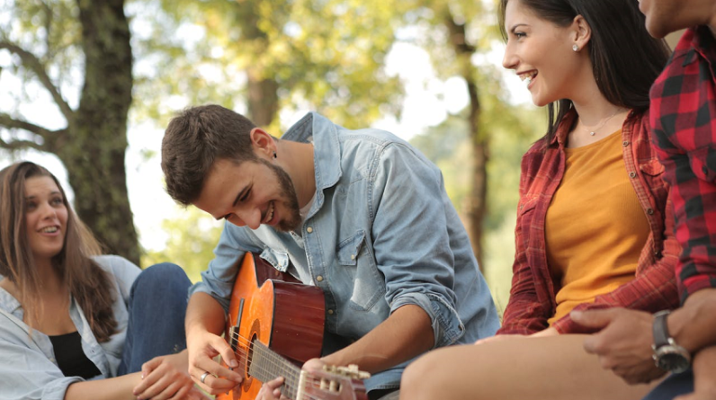 friends enjoying music outside in nature