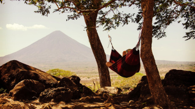 woman relaxing outside in a hammock