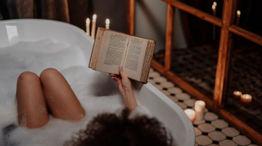 woman relaxing and reading in a bath