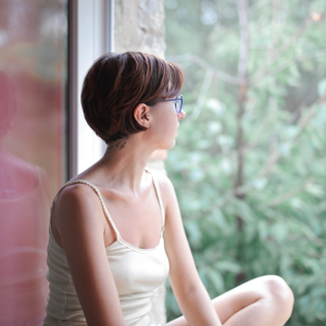 woman relaxing and looking out the window at nature