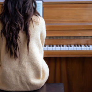 woman learning how to play piano