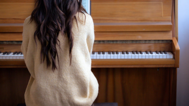 woman learning how to play piano