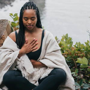 woman sitting outside practicing mindfulness for inner peace