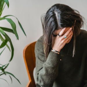 worried woman with head in her hand