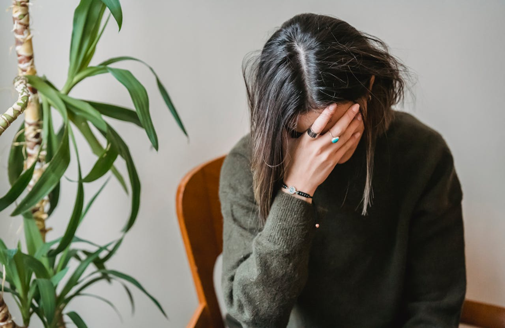 worried woman with head in her hand